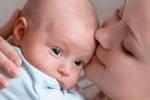 Beautiful baby of three months old in his mothers hands.